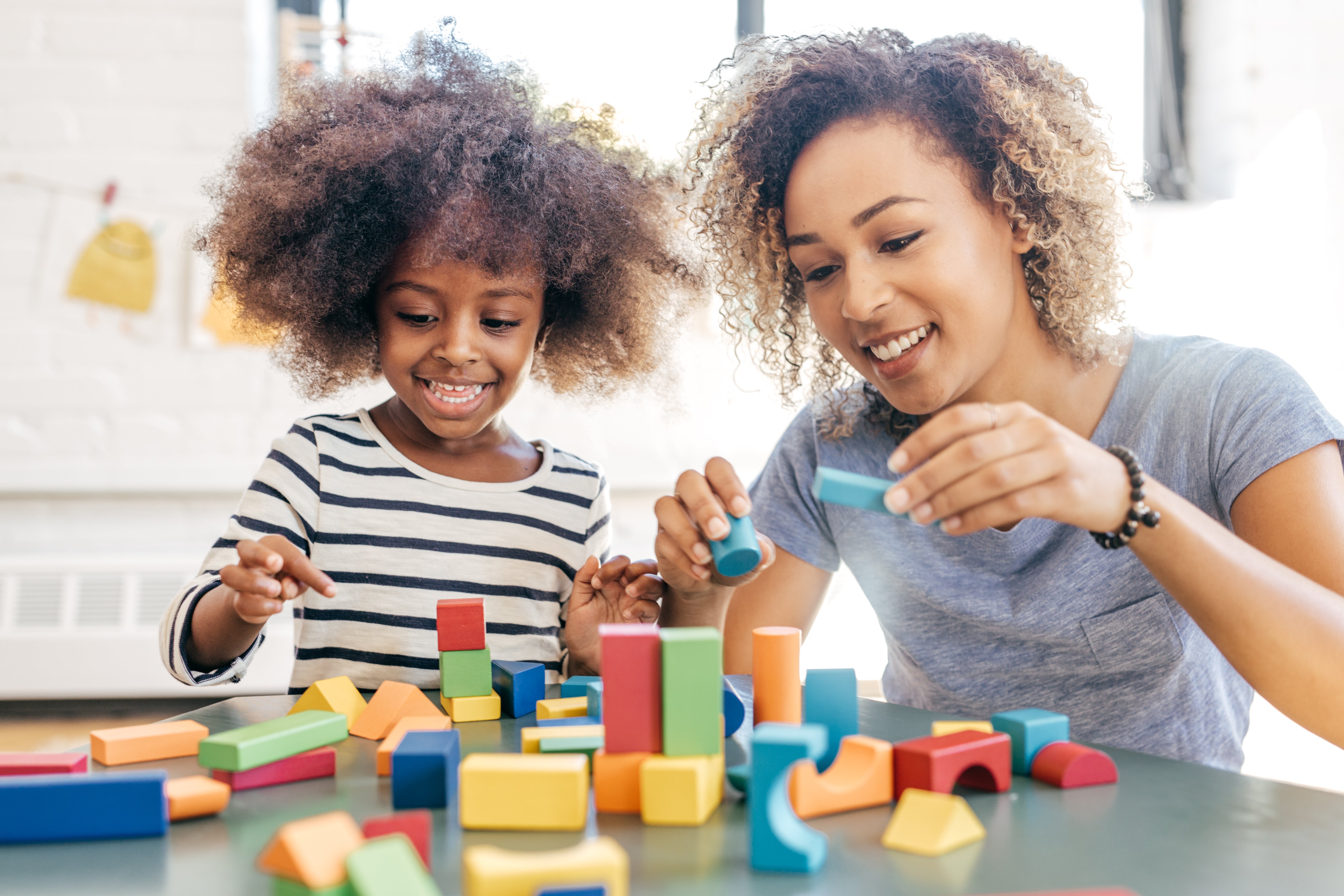 adult and child playing with blocks