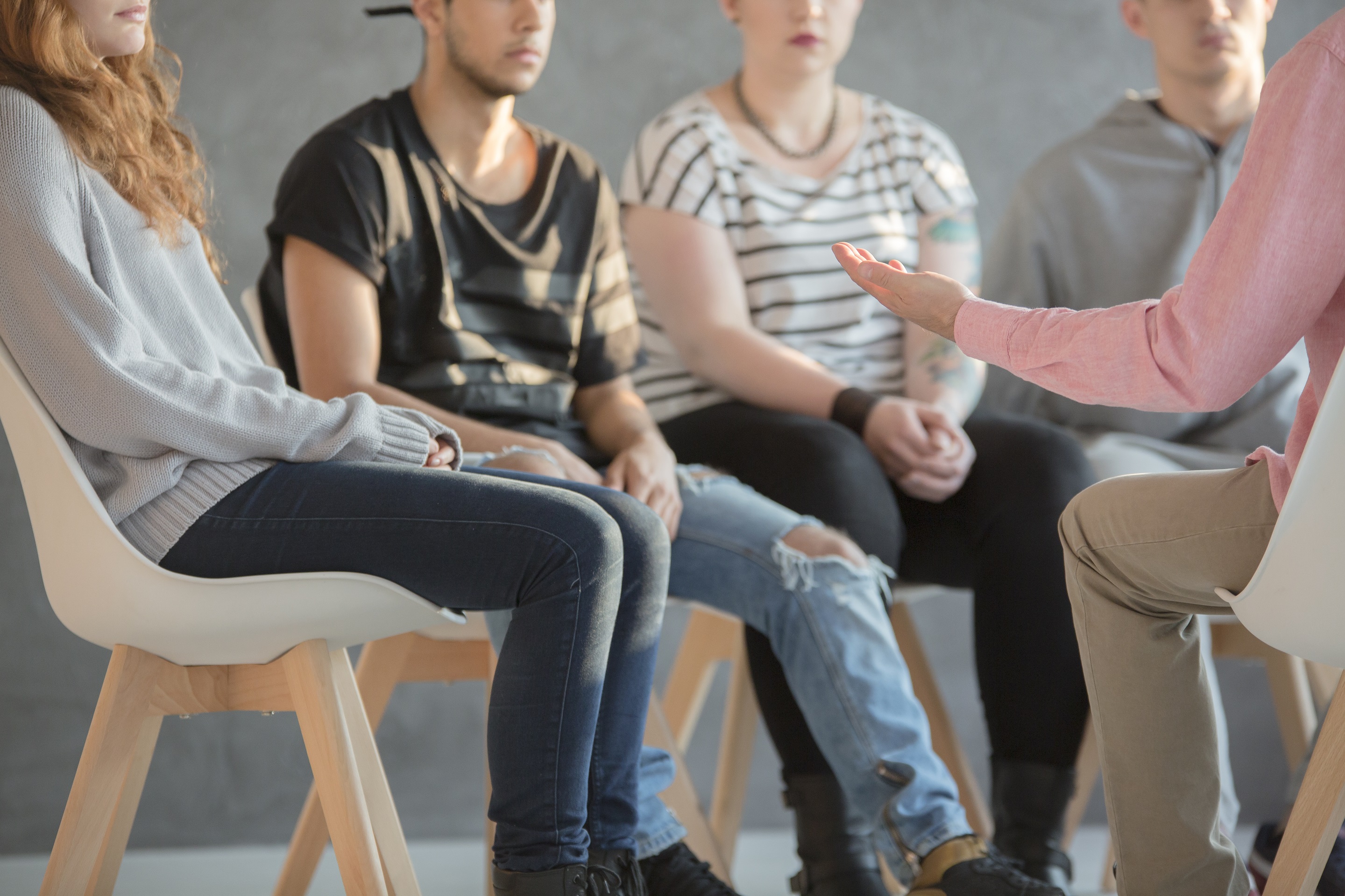 group of youth sitting in a circle talking