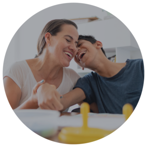 women and boy laughing with heads close together