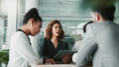 A group of executives in discussion around a table