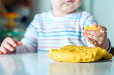 two young girls playing with playdoh
