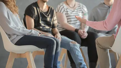 group of youth sitting in a circle talking