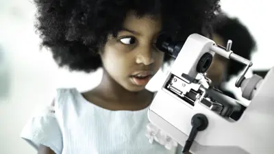 black girl looking through microscope